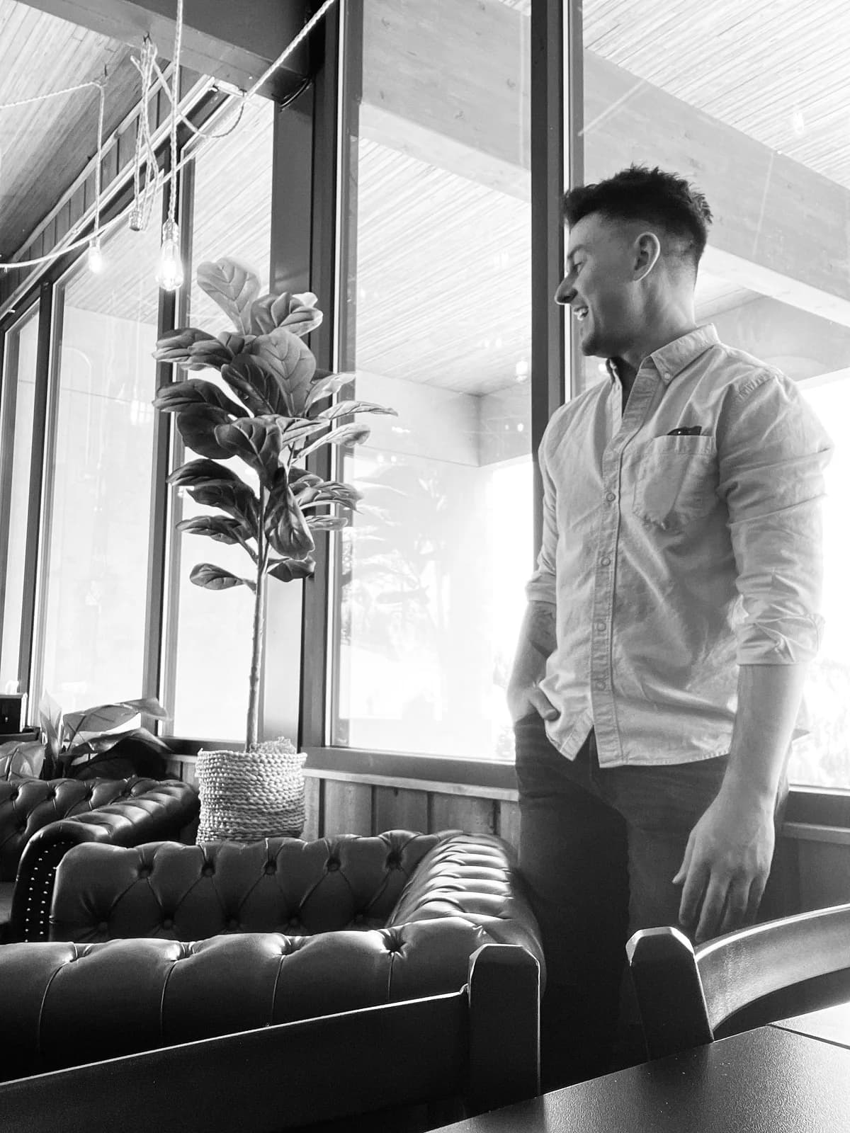 David Ballew standing beside a window.