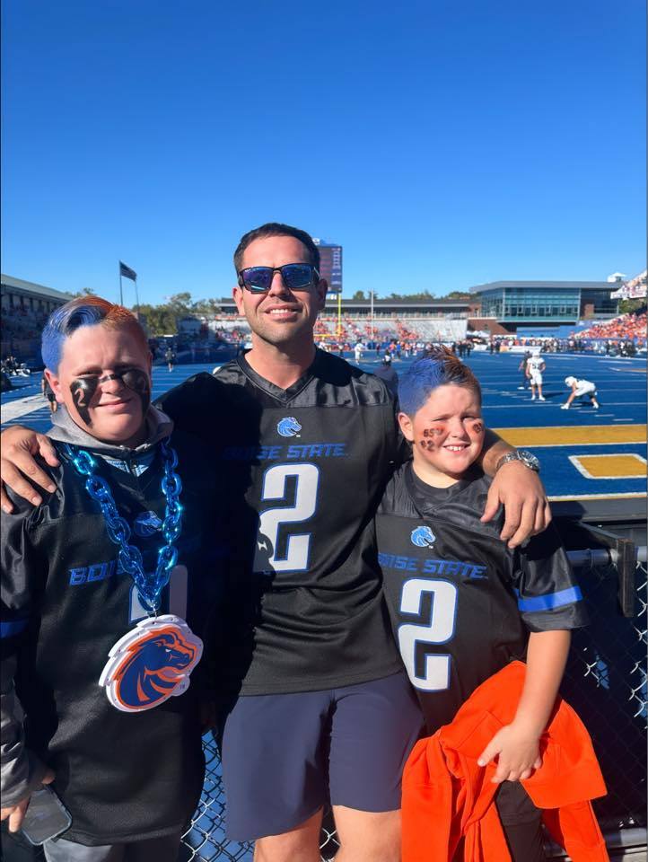 Eric with his sons at a Boise State game